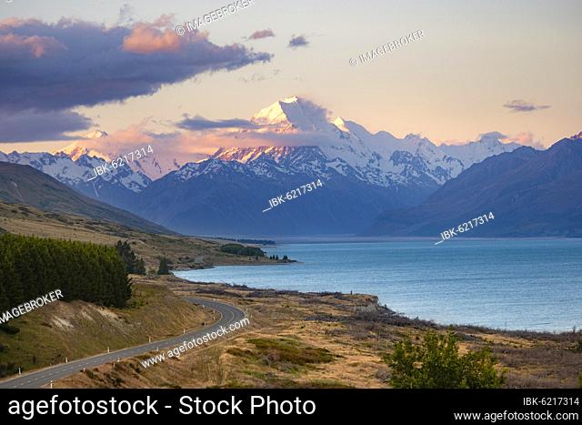 View of Mount Cook with road and lake, sunset, Lake Pukaki, Mount Cook National Park, Southern Alps, Canterbury, South Island, New Zealand, Oceania