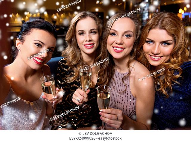 friends, bachelorette party, technology and holidays concept - happy smiling young pretty women with champagne glasses taking selfie at night club