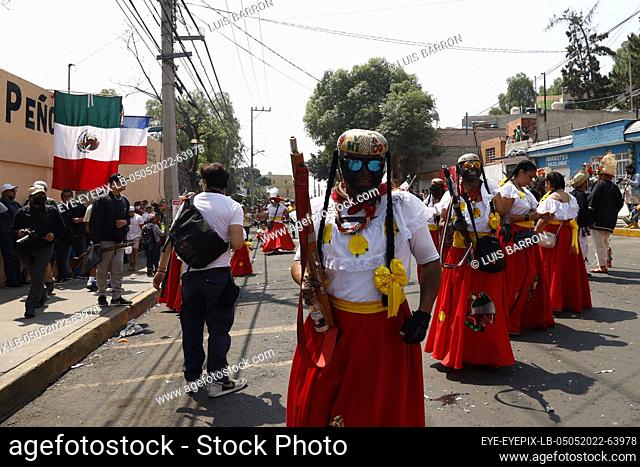 MEXICO CITY, MEXICO - MAY 5, 2022: Inhabitants of Peñón de los Baños neighborhood take part during a reenactment to commemorate the 160th anniversary of the...