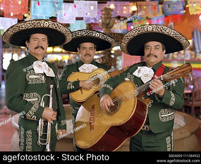 Hispanic mariachi musicians holding instruments