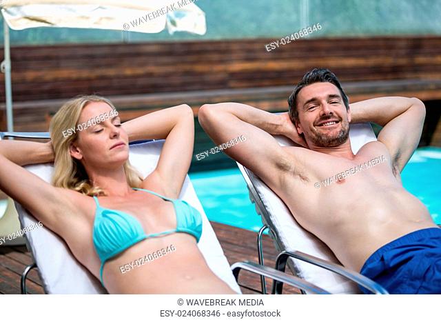 Couple relaxing on a sun lounger