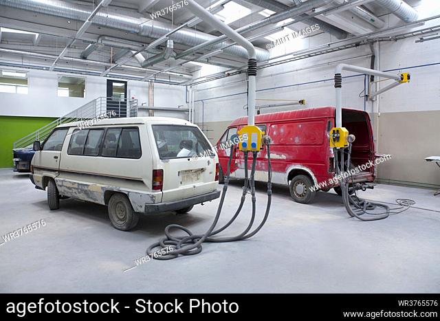 Two vans in a large repair workshop for repair and respraying