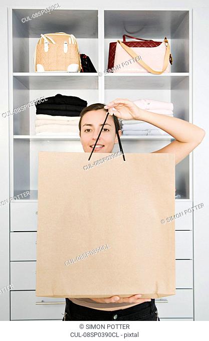 Woman holding up a shopping bag