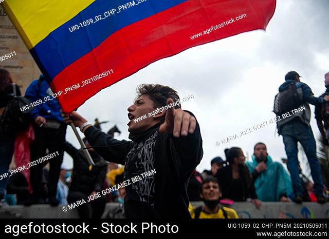 A demonstrator chants and waves a Colombian flag on may 5, 2021 in Bogota, Colombia. After police brutality cases escalated to at least 19 dead amid protests...