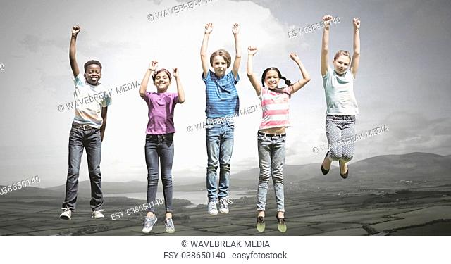 Children jumping for joy into sky with natural landscape
