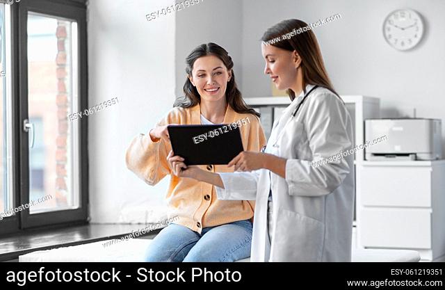 female doctor with tablet pc and woman at hospital