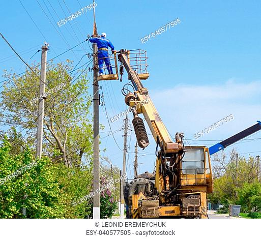 Slavyansk-on-Kuban, Russia - 24 April, 2018: Electricians repair the power line. Workers are locksmith electricians