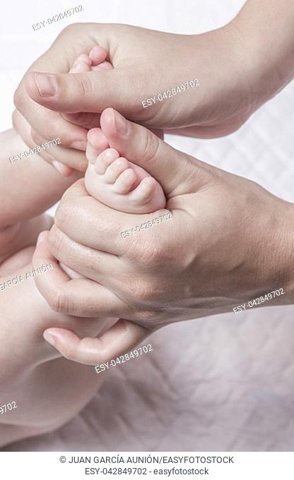 Feet massage to 3 month baby boy. thumb-over-thumb motion from heel to toes