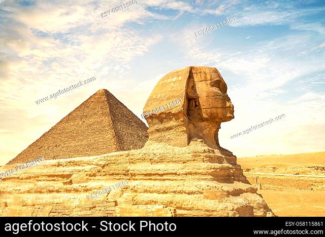 Sunny sunet over Sphinx and pyramid in Egypt