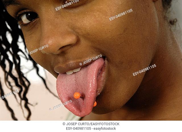 teenager with tongue piercing