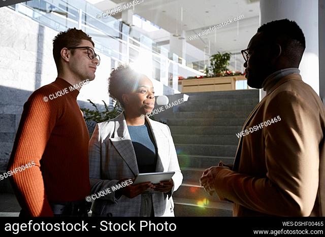 Businessman discussing with colleagues in modern office