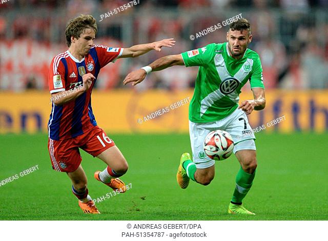 Munich's Gianluca Gaudino (L) and Wolfsburg's Daniel Caligiuri in action during the German Bundesliga match between FC Bayern Munich and VfL Wolfsburg at...