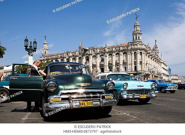Cuba, Ciudad de La Habana Province, Havana, Centro Habana District, American car in front of the Havana Great Theater (Gran Teatro de La Habana) in Neo Baroque...