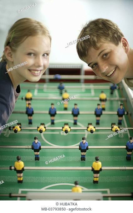 boy, girls, table football, play,  Look camera, laughing, detail  Series, children, siblings, 9-14 years, table soccer games, table soccer game, together