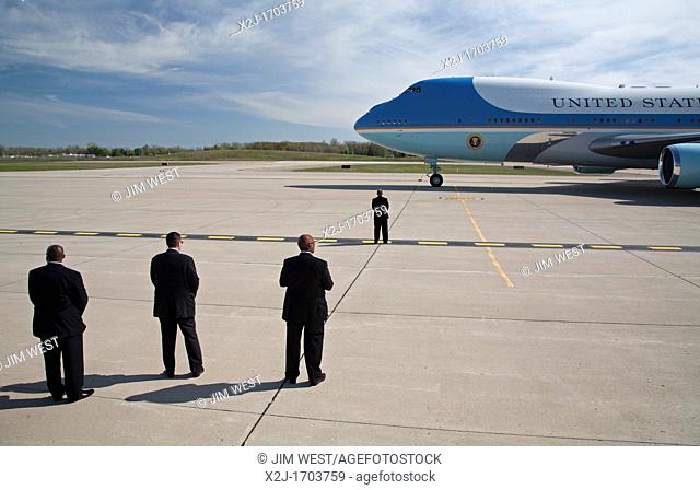 Detroit, Michigan - Security personnel stand watch as President Barack Obama arrives at Detroit Metro Airport on Air Force 1