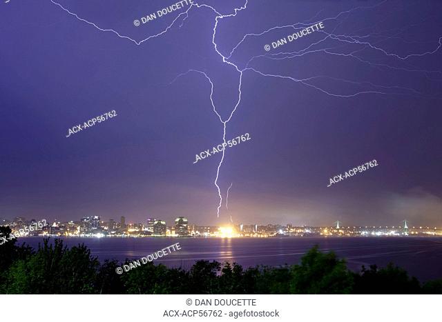 A bolt lightning fills the sky over Halifax Harbour and strikes a communications tower in Halifax, Nova Scotia