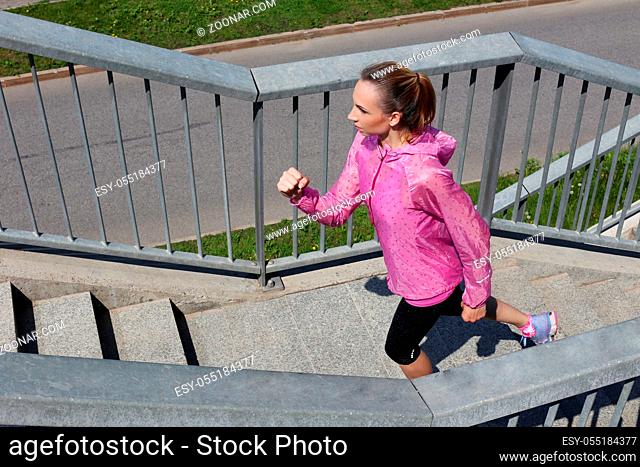Sport, activity. Cute woman running on the street