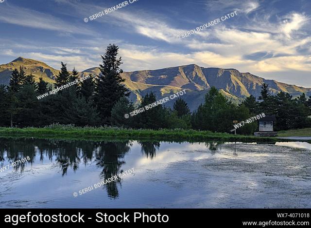 Bassa d'Arres lake in a summer sunrise with full Moon, near Arres de Sus village and the Montlude peak (Aran Valley, Catalonia, Spain, Pyrenees)