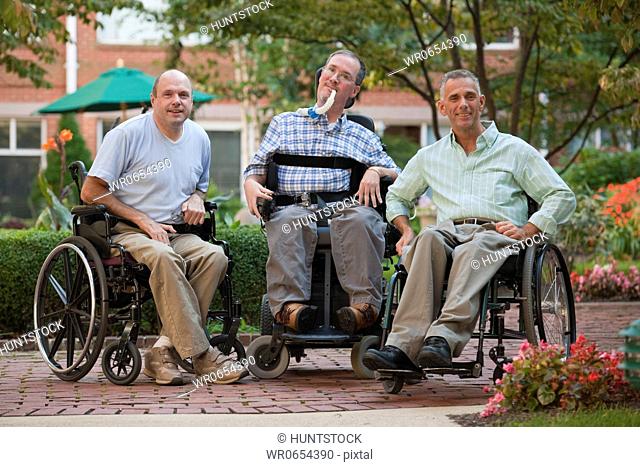 Three men sitting in wheelchairs
