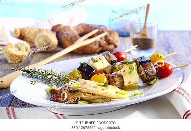 Feta cheese and vegetables skewers with mushroom antipasti and bread