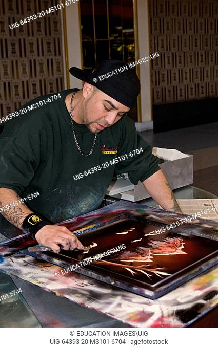 Las Vegas, Nevada, Street artist working on a painting for a customer