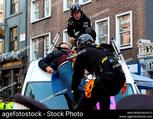 Extinction Rebellion protesters attached themselves to the top of a van. Police team removed them before arrest on the first day of the 'Impossible Rebellion...