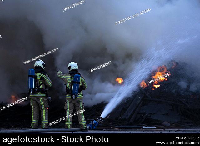 Fire fighters pictured at the site of IOK recycling and waste management company, in Beerse, Monday 28 March 2022. BELGA PHOTO KRISTOF VAN ACCOM