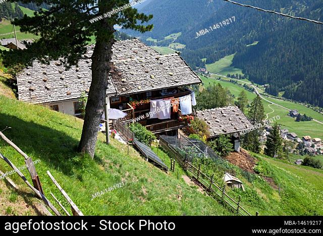 Mountain farms on the steep slope high above the valley floor in the South Tyrolean Ulten Valley