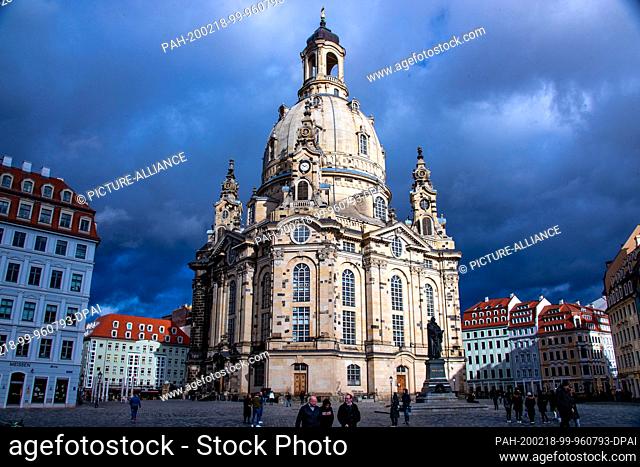 10 February 2020, Saxony, Dresden: The Frauenkirche is illuminated by the winter sun in front of a dark cloud scenery. Photo: Jens Büttner/dpa-Zentralbild/ZB