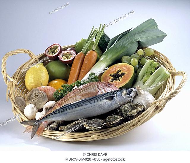 Basket of vegetables, fruits, exotic fruits, fishes and shells