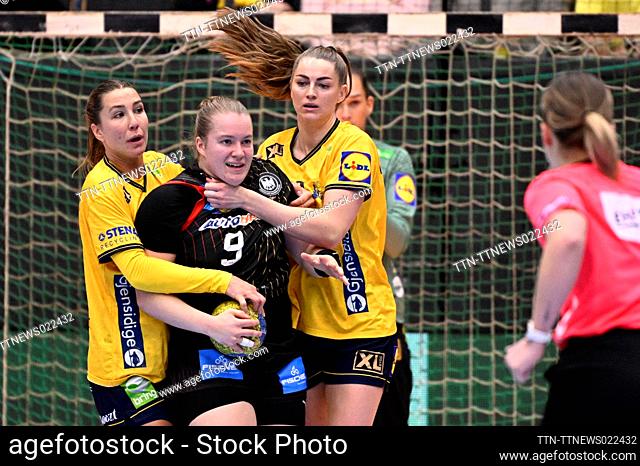 Sweden's Anna Lagerquist and Kristin Thorleifsdóttir handle Germany's Lisa Antl a bit to hard according to the referee during a women's friendly handball match...