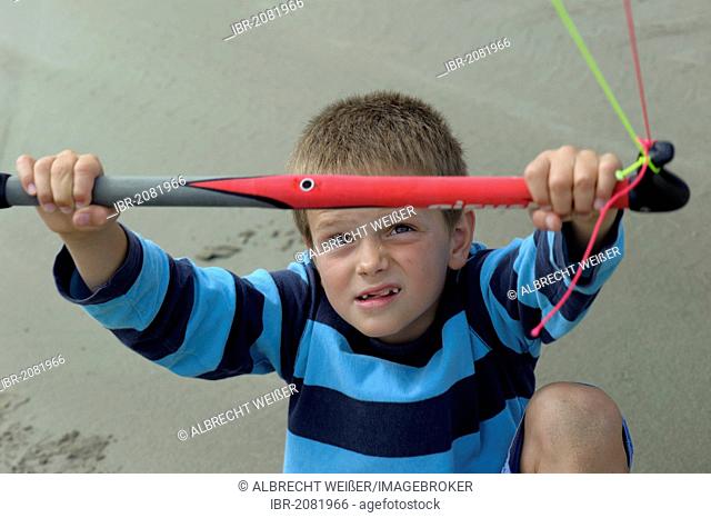 Boy flying a towing kite on the Atlantic beach, Finistere, Bretagne, Britanny, France, Europe, PublicGround