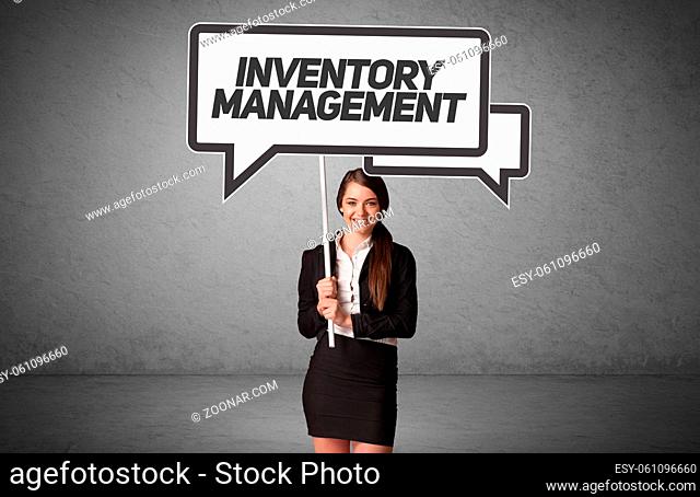 Young business person in casual holding road sign with INVENTORY MANAGEMENT inscription, new business idea concept