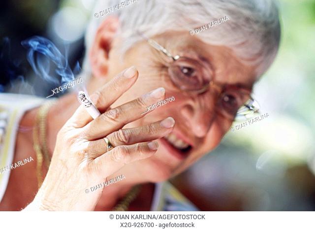 An old lady smoking a cigarette