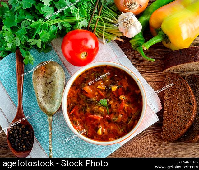 The bowl of traditional soup borscht on table
