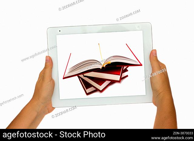 hand holding modern tablet PC with pile of books in it - e-learning concept