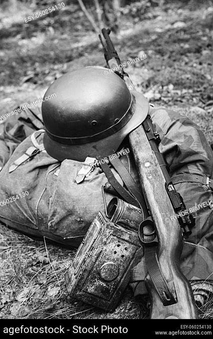 World War II German Wehrmacht Soldier Ammunition Of World War II On Ground. WWII Military Helmet, Lights, Rifle Mauser Karabiner 98K