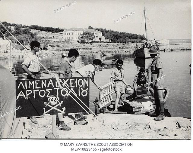 Scouts landing materials at Limenarchio, Argostolion, Kefalonia, Greece. Four earthquakes hit the island in August 1953, destroying many buildings; the scouts...