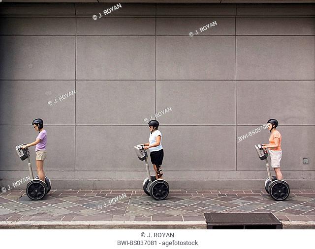three people with Segway-scooters, USA, Louisiana