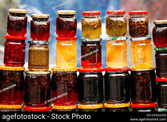 Various Jars With Sweet Tasty Yummy Jams Stading In Rows. Jam Made From Walnuts, Pine Cones, Walnuts, Honey. Traditional Healthy Cuisine