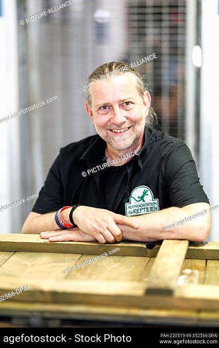 19 May 2022, Bavaria, Munich: Markus Baur, veterinarian and head of the reptile sanctuary, looks into the camera in front of the enclosure of Puma Pele