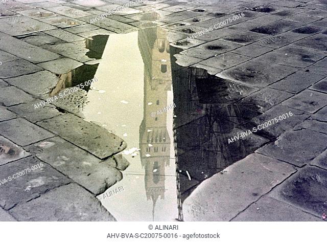 Tower (Tower of Arnolfo) of the Palazzo Vecchio in Florence reflected in a puddle, shot 12/1961 by Balocchi Vincenzo