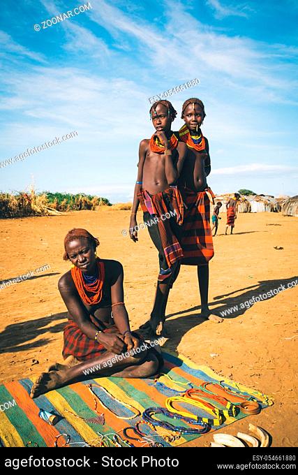 Omorate, Omo Valley, Ethiopia - May 11, 2019: Woman from the African tribe Dasanesh offering handmade souvenirs. Daasanach are Cushitic ethnic group inhabiting...
