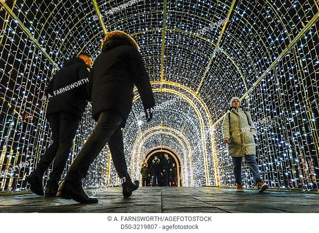 Gdansk, Poland Christmas decorations in a light tunnel at the Forum Mall and pedestrians