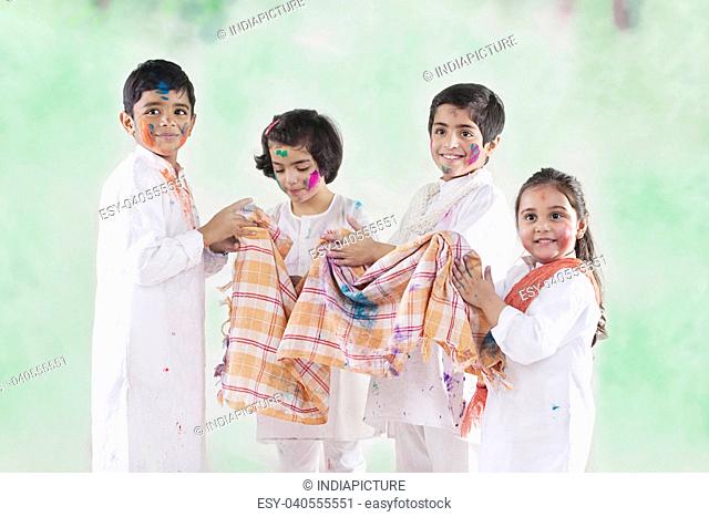 Children wiping their hands on a cloth
