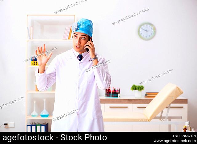 Young male doctor otolaryngologist working at the hospital