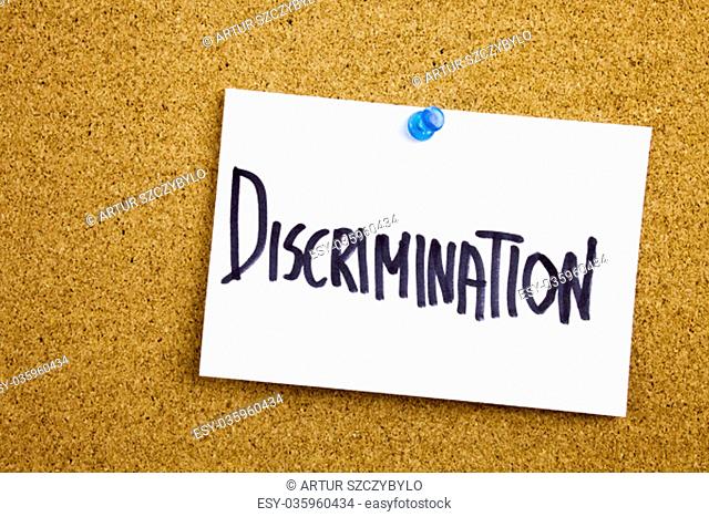 Phrase DISCRIMINATION in black ext on a sticky note pinned to a cork notice board