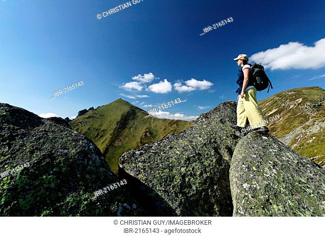 Hiker in the Massif du Sancy, Parc Naturel Regional des Volcans d'Auvergne, Regional Nature Park of the Volcanoes of Auvergne, Monts Dore, Puy de Dome, France