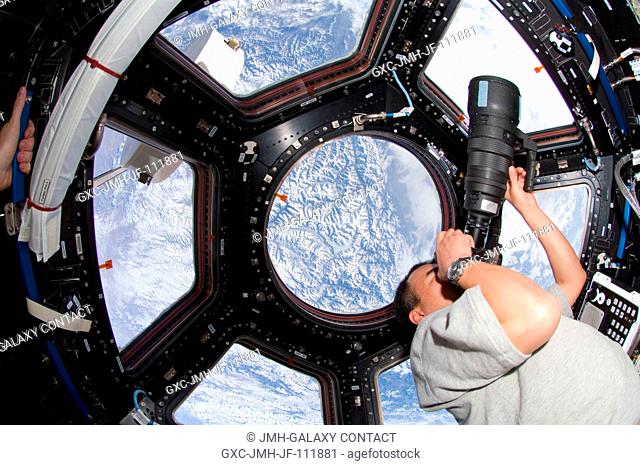 Japan Aerospace Exploration Agency (JAXA) astronaut Soichi Noguchi, Expedition 22 flight engineer, uses a still camera to photograph the topography of a point...