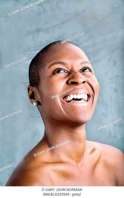 Portrait of smiling Black woman looking up